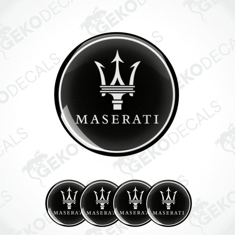A set of four black vinyl stickers with the Maserati logo in the center.