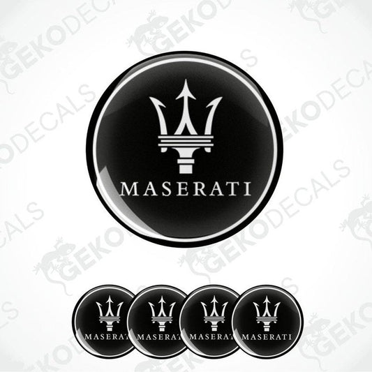 A set of four black vinyl stickers with the Maserati logo in the center.