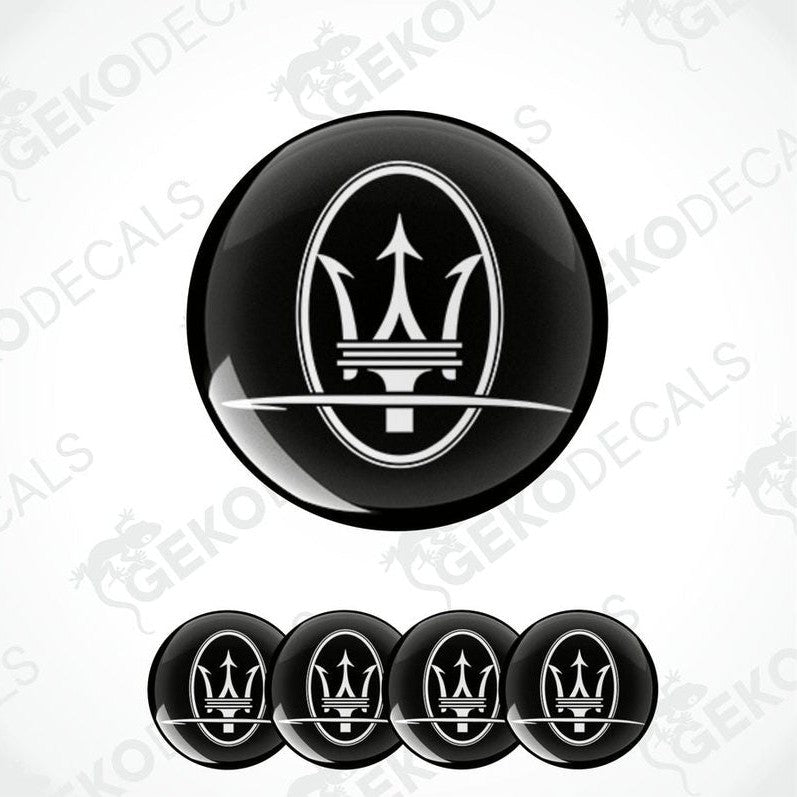 A set of four black vinyl stickers with a geometric design representing the Maserati brand logo.