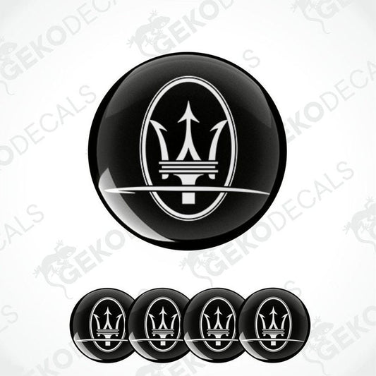 A set of four black vinyl stickers with a geometric design representing the Maserati brand logo.