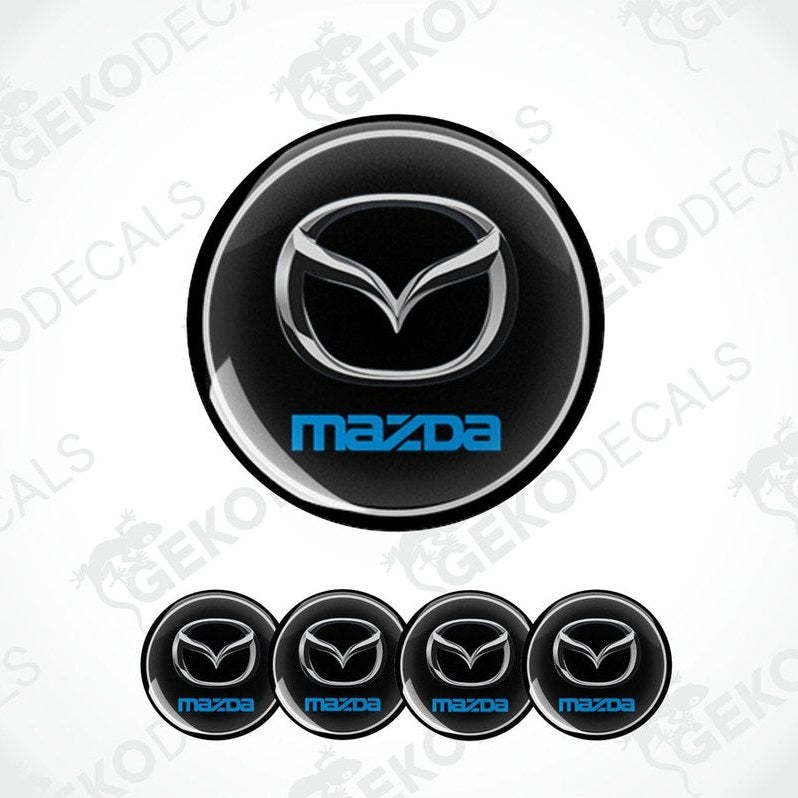 A set of black vinyl decals with the Mazda logo in silver and blue.