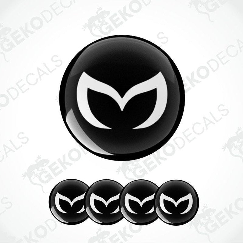 A set of four black vinyl stickers with a white Mazda logo on each.