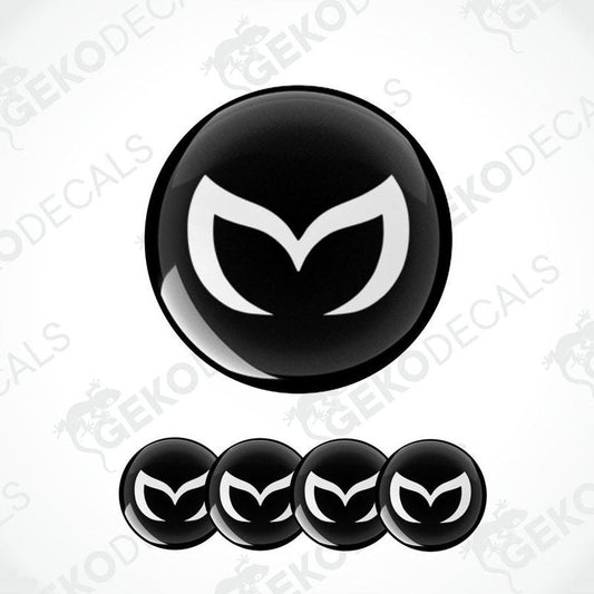 A set of four black vinyl stickers with a white Mazda logo on each.