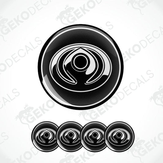 A set of four black vinyl decals with a polyurethane coating and a spiral design, branded for Mazda.