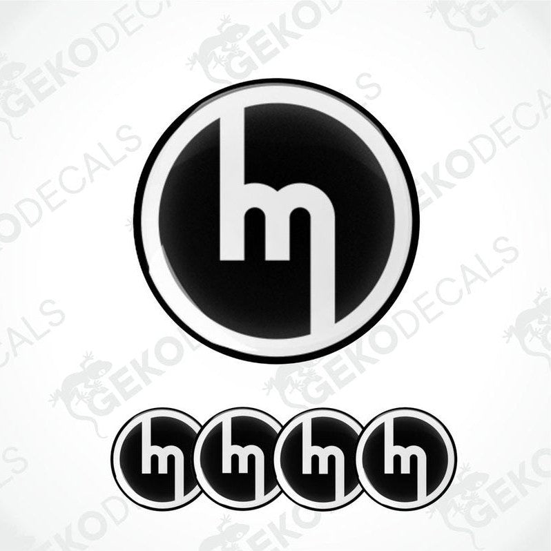 A set of four black and white vinyl decals with the MAZDA logo design.