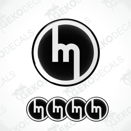 A set of four black and white vinyl decals with the MAZDA logo design.