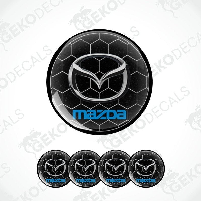 A set of four black and blue Mazda branded vinyl decals, three shown on a car and one on a white background.