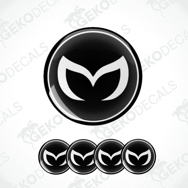 A set of four black vinyl stickers with a white Mazda logo on each.