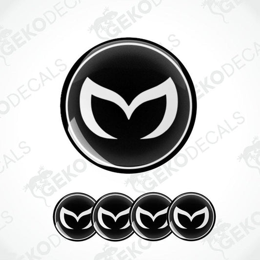 A set of four black vinyl stickers with a white Mazda logo on each.