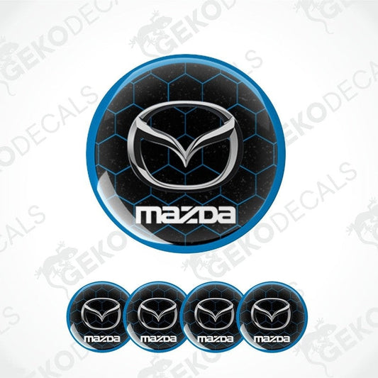 A set of four round MAZDA branded vinyl stickers with a geometric pattern and a blue and black color scheme.
