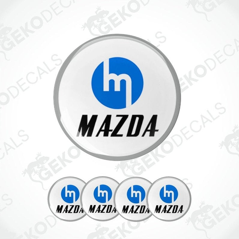 A set of four blue Mazda logo decals with a white background.