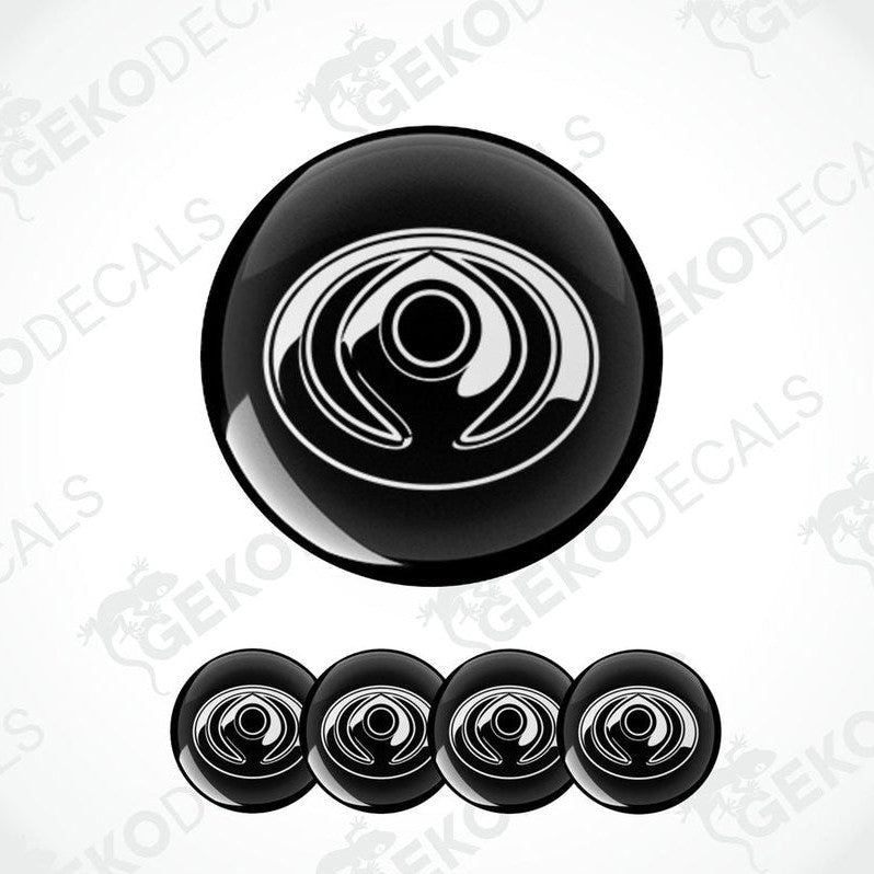 A set of four black vinyl decals with a polyurethane coating and a spiral design, branded for Mazda.