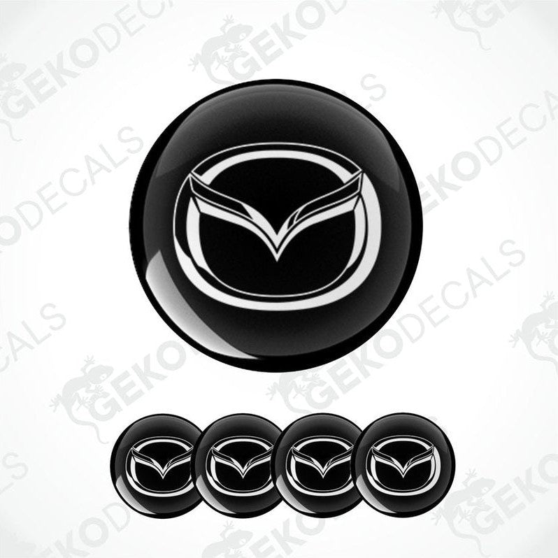A set of four black vinyl stickers with a geometric design, including the MAZDA brand logo.