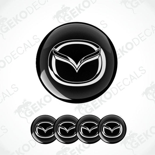 A set of four black vinyl stickers with a geometric design, including the MAZDA brand logo.