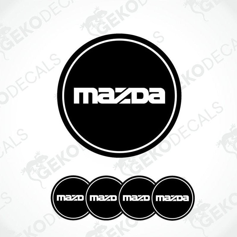 A set of four black vinyl stickers with the Mazda logo on them.