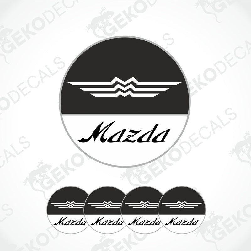 A set of four round MAZDA branded vinyl stickers with a black, white, and gray color scheme on a white background.