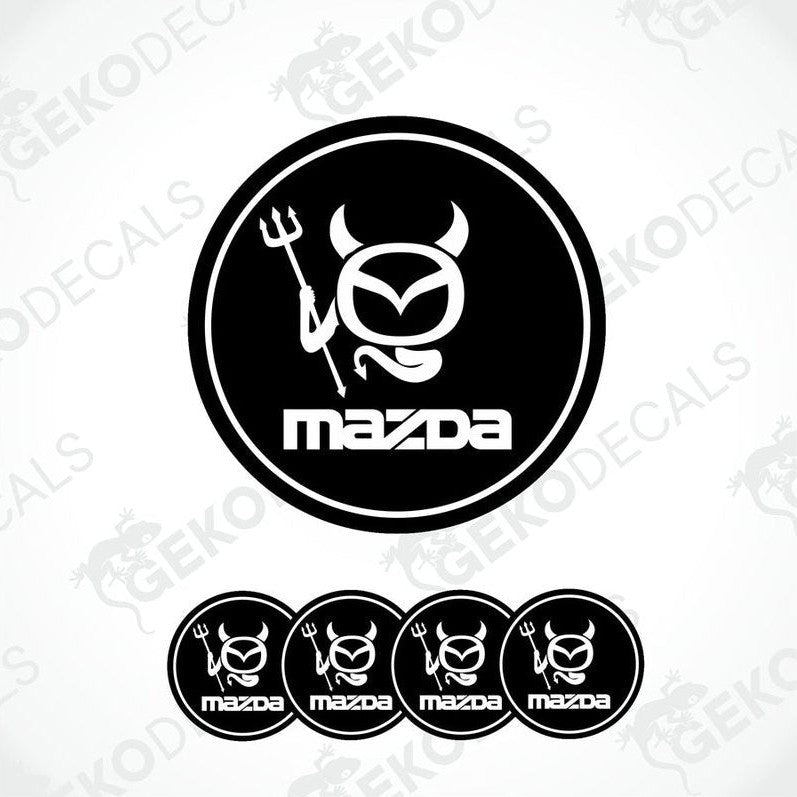 A set of black and white vinyl decals with polyurethane coating featuring a Mazda logo with a stylized horned figure.