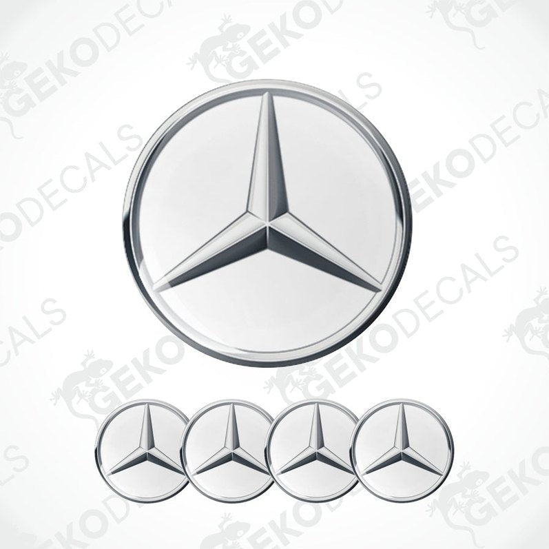 A set of four silver Mercedes-Benz emblem stickers with a polyurethane coating, displayed against a white background.