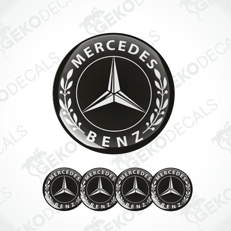 A set of four black vinyl stickers with the Mercedes-Benz logo, including a round emblem and four smaller rectangular stickers.