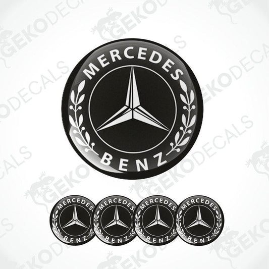 A set of four black vinyl stickers with the Mercedes-Benz logo, including a round emblem and four smaller rectangular stickers.