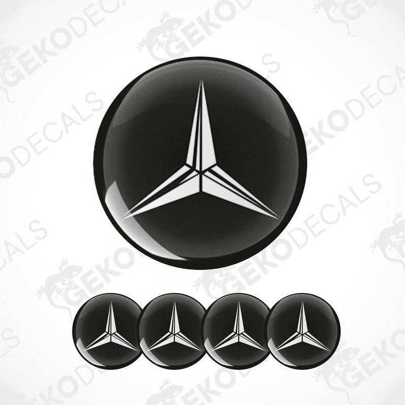 A set of four black and white vinyl stickers with a geometric design, including a prominent Mercedes-Benz logo.