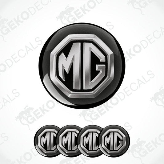 A set of four black and silver vinyl decals with the MG logo, designed for use as car wheel caps.