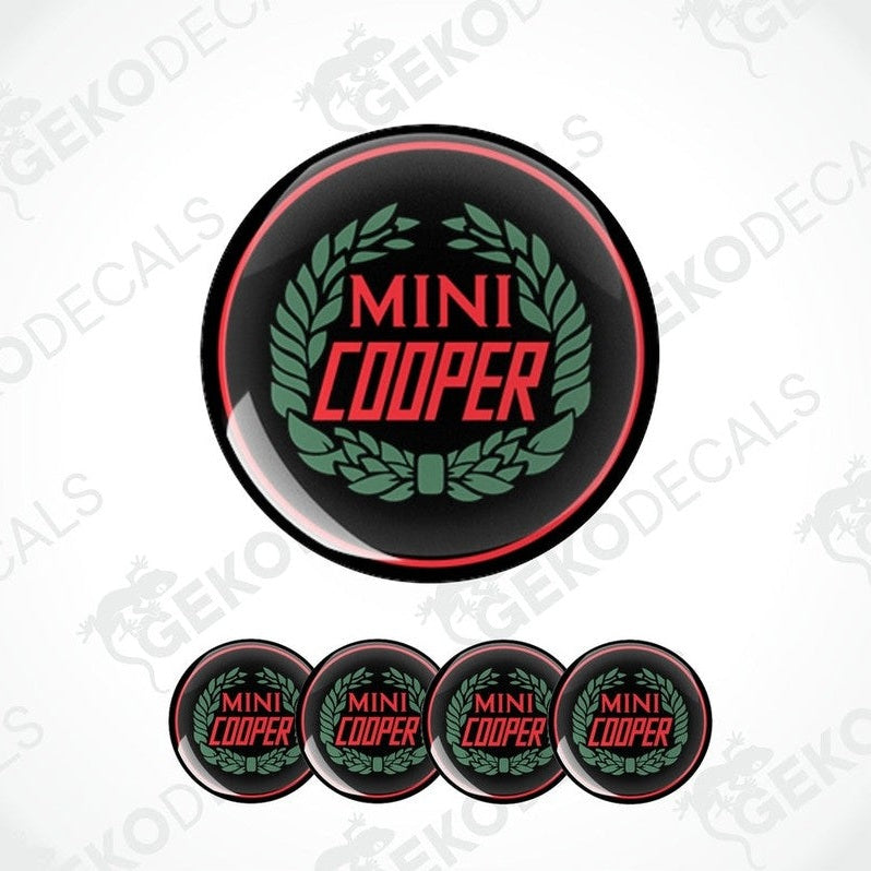 A set of four black, red, and green vinyl stickers with the text 'MINI COOPER' in the center.