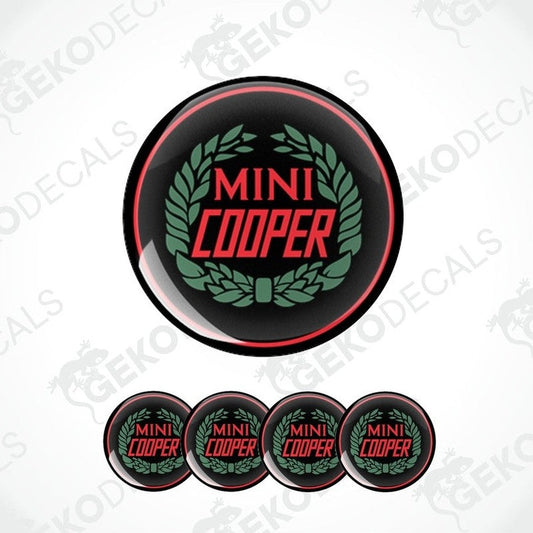 A set of four black, red, and green vinyl stickers with the text 'MINI COOPER' in the center.