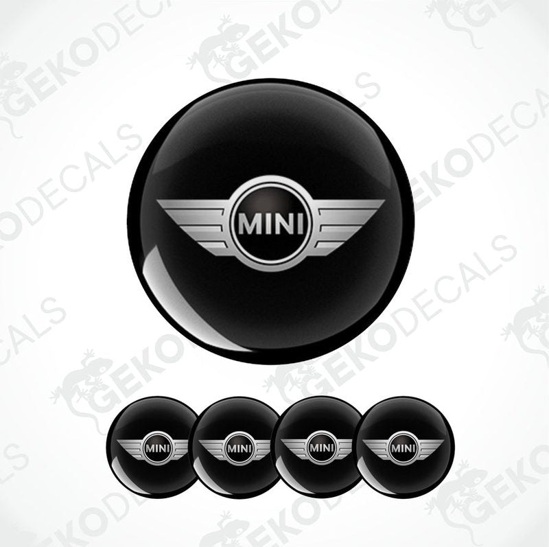 A set of four black vinyl stickers with the word 'MINI COOPR' in the center, designed to be applied on car wheels.
