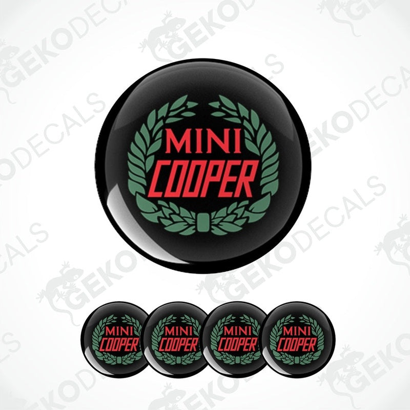A set of four black, red, and green vinyl stickers with the text 'MINI COOPER' in the center.