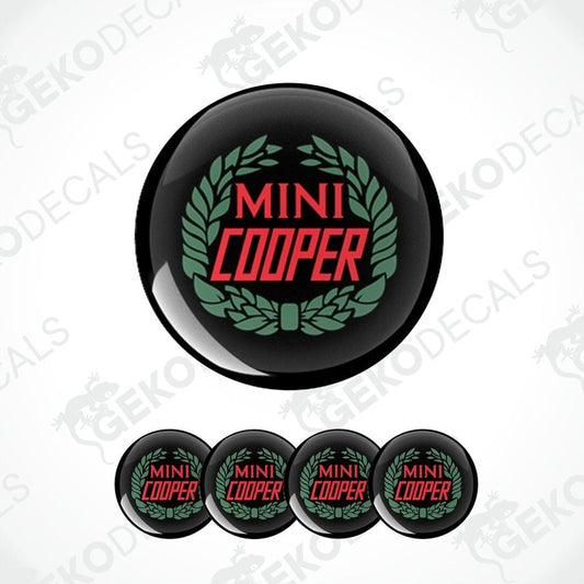 A set of four black, red, and green vinyl stickers with the text 'MINI COOPER' in the center.