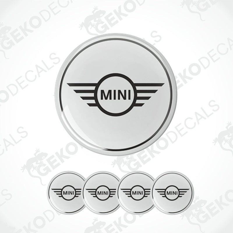 A set of round car decals for a MINI COOPER, with one large decal featuring the MINI logo and three smaller ones for wheels.