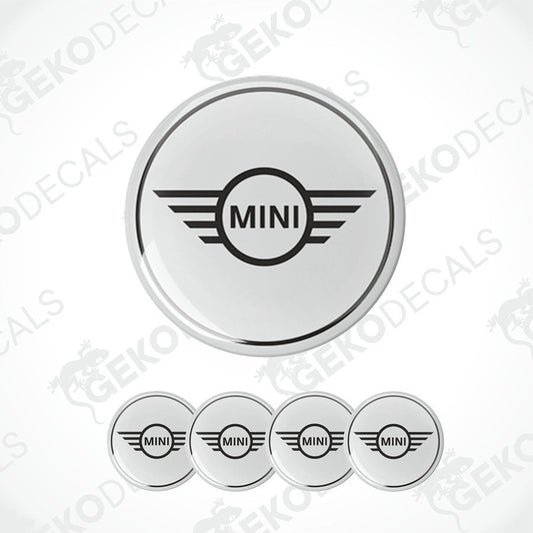 A set of round car decals for a MINI COOPER, with one large decal featuring the MINI logo and three smaller ones for wheels.