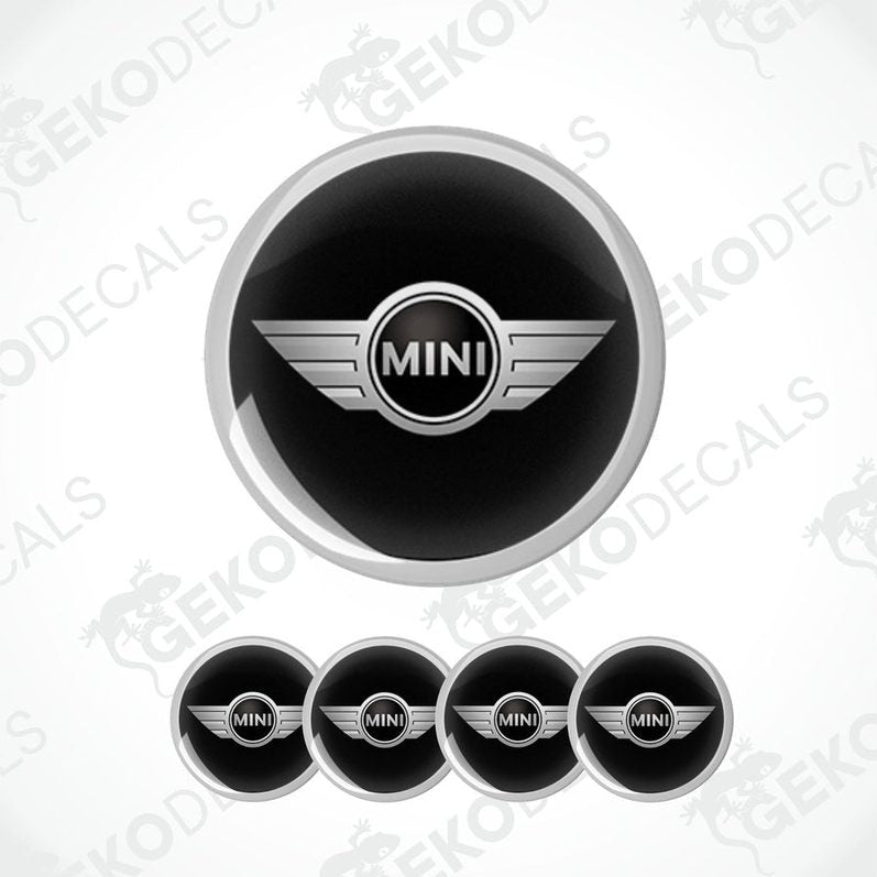 A set of four black vinyl stickers with the word 'MINI COOPR' in the center, designed to be applied on car wheels.