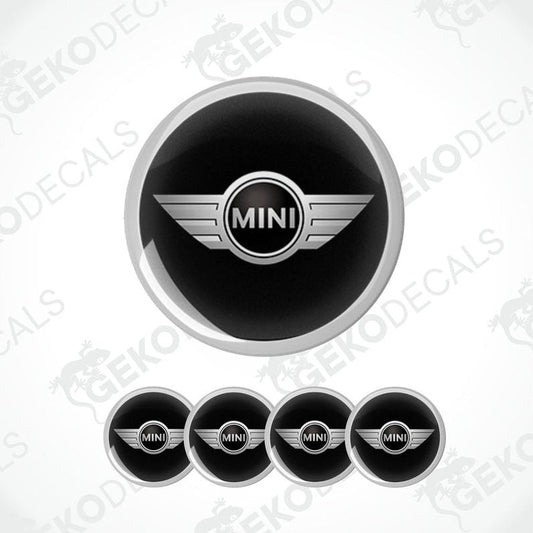 A set of four black vinyl stickers with the word 'MINI COOPR' in the center, designed to be applied on car wheels.