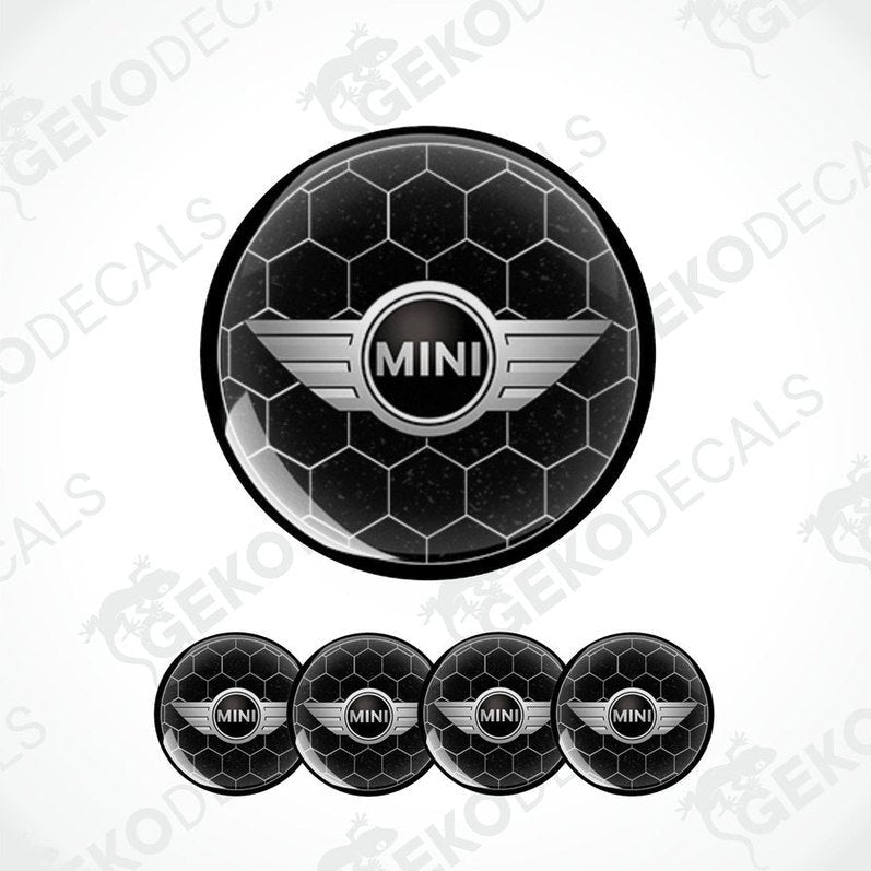 A set of four black vinyl stickers with the text 'MINI COOPER' and a graphical design in the center, arranged in a circular pattern with a Gecko Decals logo at the top.