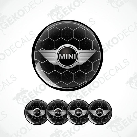 A set of four black vinyl stickers with the text 'MINI COOPER' and a graphical design in the center, arranged in a circular pattern with a Gecko Decals logo at the top.