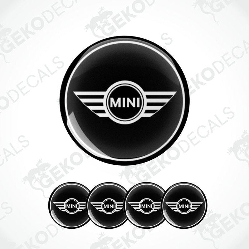 A set of black vinyl decals with the Mini Cooper logo, designed for use as car wheel stickers.