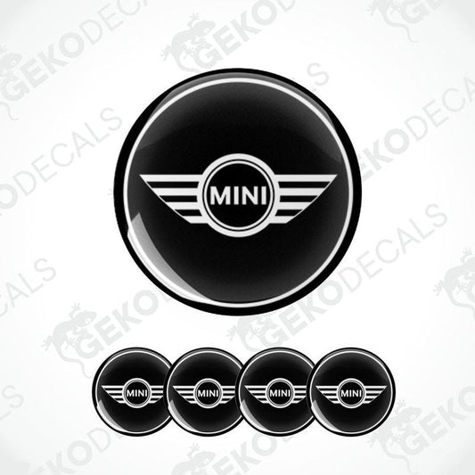 A set of black vinyl decals with the Mini Cooper logo, designed for use as car wheel stickers.
