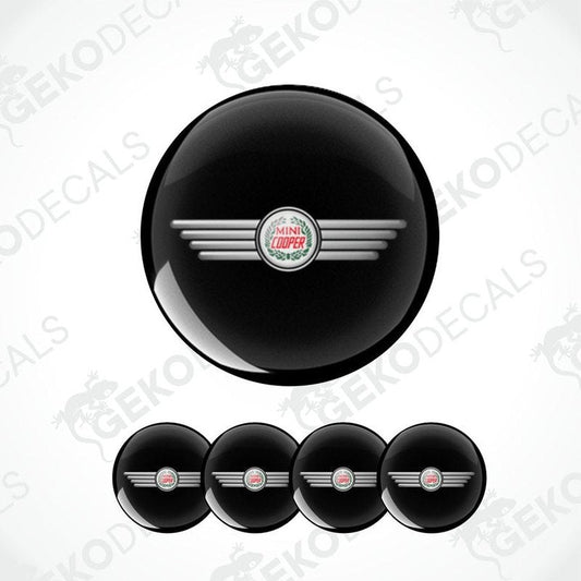 A set of black vinyl decals with a silver logo, designed for MINI COOPER vehicles, including four wheel cap decals.