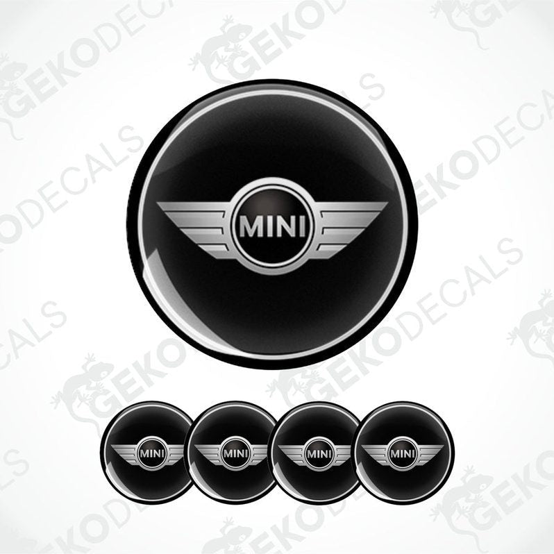 A set of four black vinyl stickers with the word 'MINI COOPR' in the center, designed to be applied on car wheels.