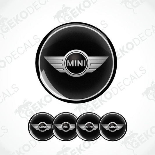A set of four black vinyl stickers with the word 'MINI COOPR' in the center, designed to be applied on car wheels.
