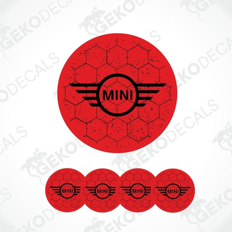 A set of four red vinyl stickers with the text 'MINI COOPER' and a graphic design resembling a stylized airplane or a winged logo.