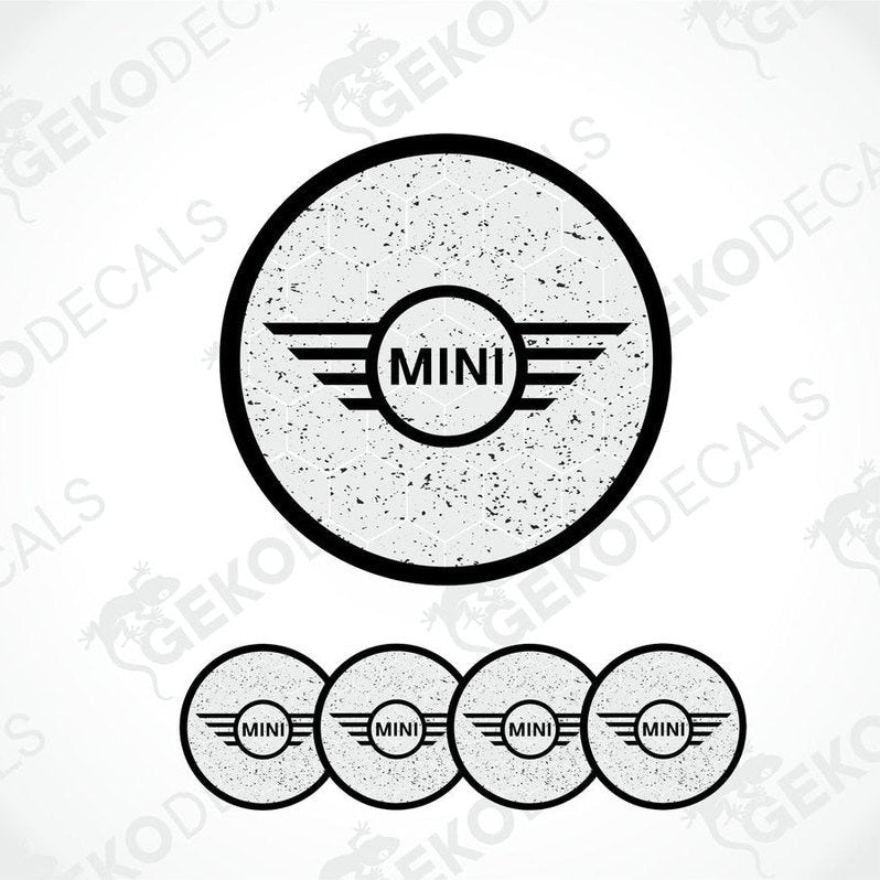A set of four gray vinyl stickers with the word 'MINI' in the center, designed for use on car wheels or other surfaces.