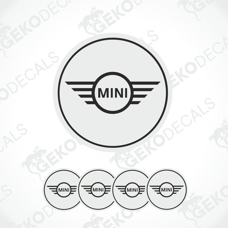 A set of round car decals for a MINI COOPER, with one large decal featuring the MINI logo and three smaller ones for wheels.