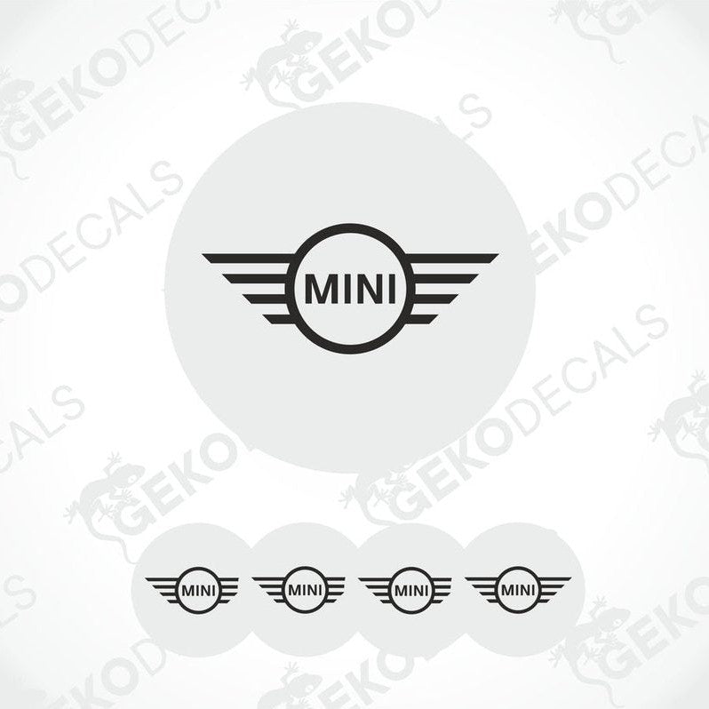 A set of four white vinyl stickers with the MINI Cooper brand logo in the center, designed for use on car wheels or other surfaces.
