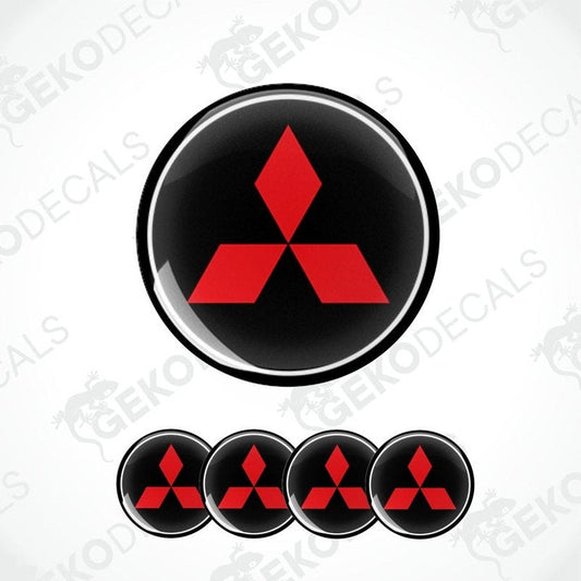 A set of four round car decals featuring the Mitsubishi logo in red on a black background.