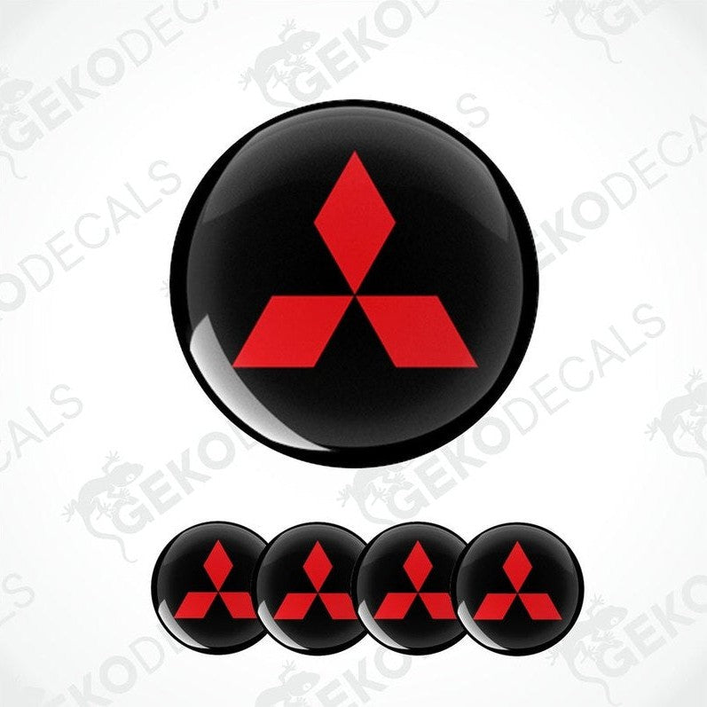 A set of four round car decals featuring the Mitsubishi logo in red on a black background.