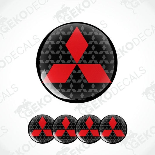A set of four round car decals with the Mitsubishi logo in red on a black background with a geometric pattern.