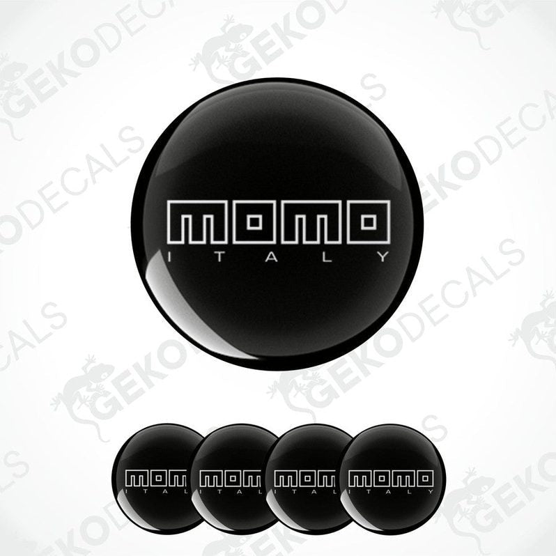 A set of black vinyl decals with the text 'momo ITALY' in white. The decals are dome-shaped and designed for use as car wheel or cap stickers.